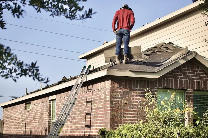 Professional roofer working on a residential roof in Harkins